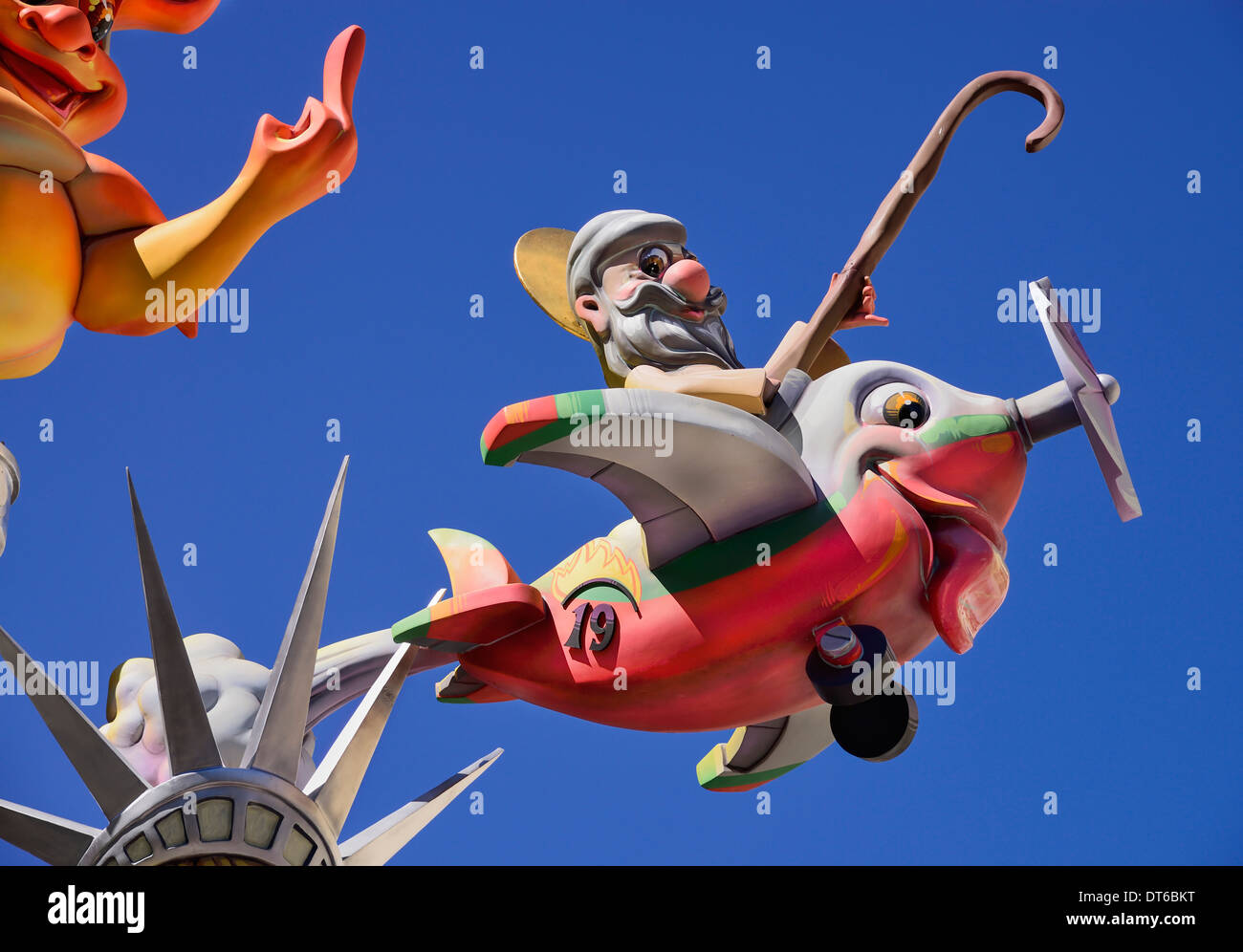 Spain, Valencia Province, Valencia, Papier Mache figure flying an airplane resembling a fish during Las Fallas festival. Stock Photo