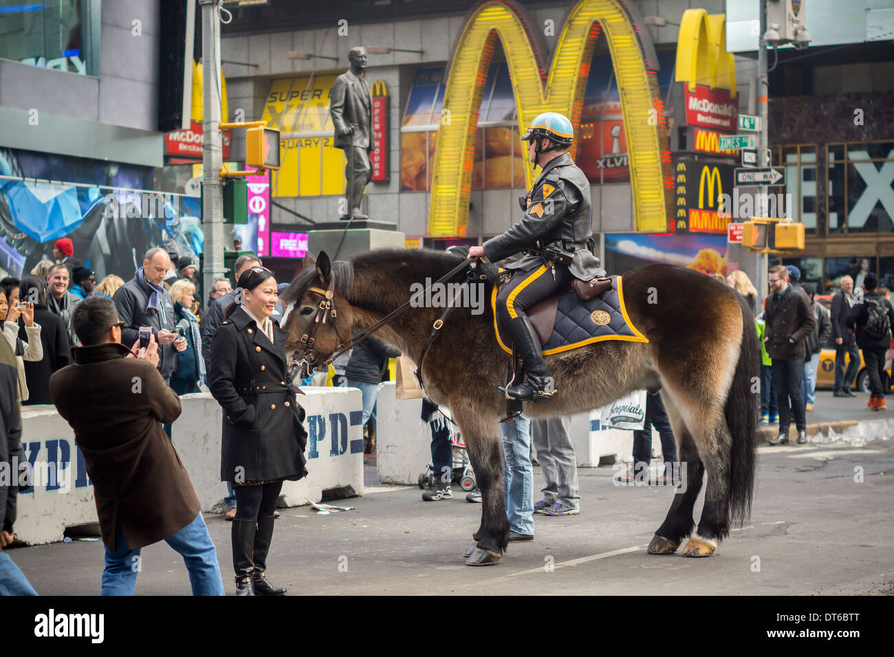 An NYPD officer entertains tourists in Times Square in New York on ...