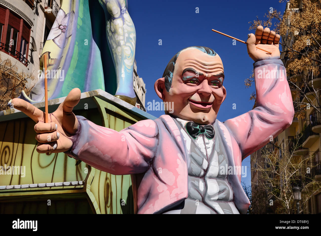 Spain, Valencia Province, Valencia, Papier Mache figure of a man in a pink jacket in the street during Las Fallas festival. Stock Photo