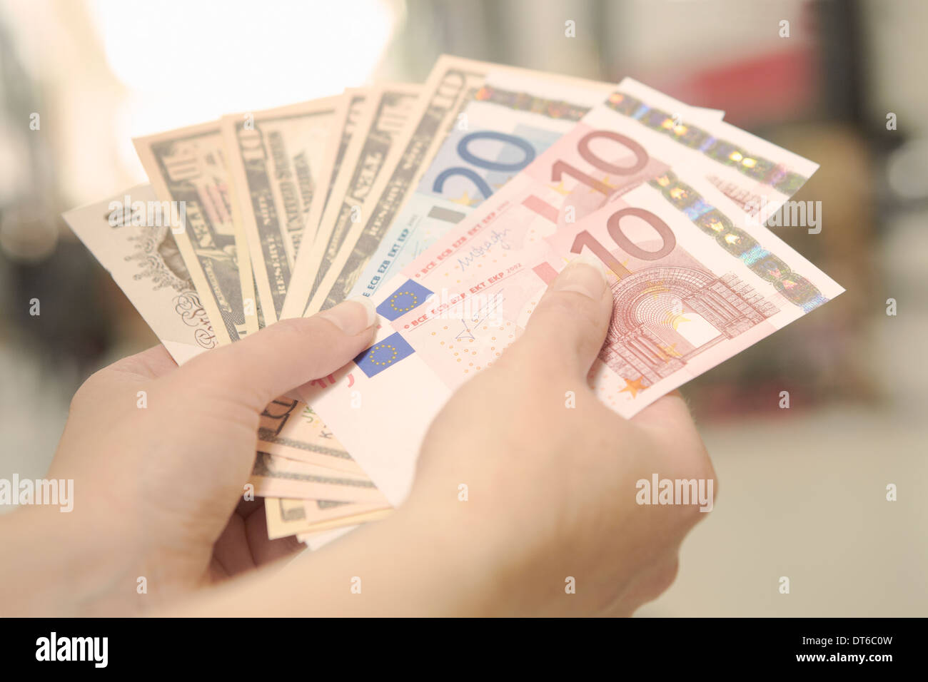 Female hands holding American, British and European bank notes Stock Photo