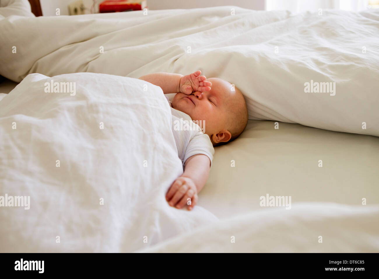 Baby girl asleep on bed Stock Photo Alamy