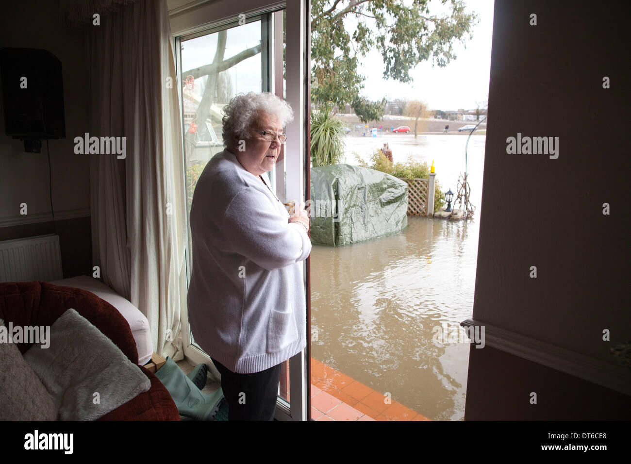 Shepperton, Greater London, UK. 9th Feb, 2014.  Margaret Yates looks out onto the river banks which have broken into the flooded streets in the town of Shepperton, located in the borough of Spelthorne, Greater London. Credit:  Jeff Gilbert/Alamy Live News Stock Photo