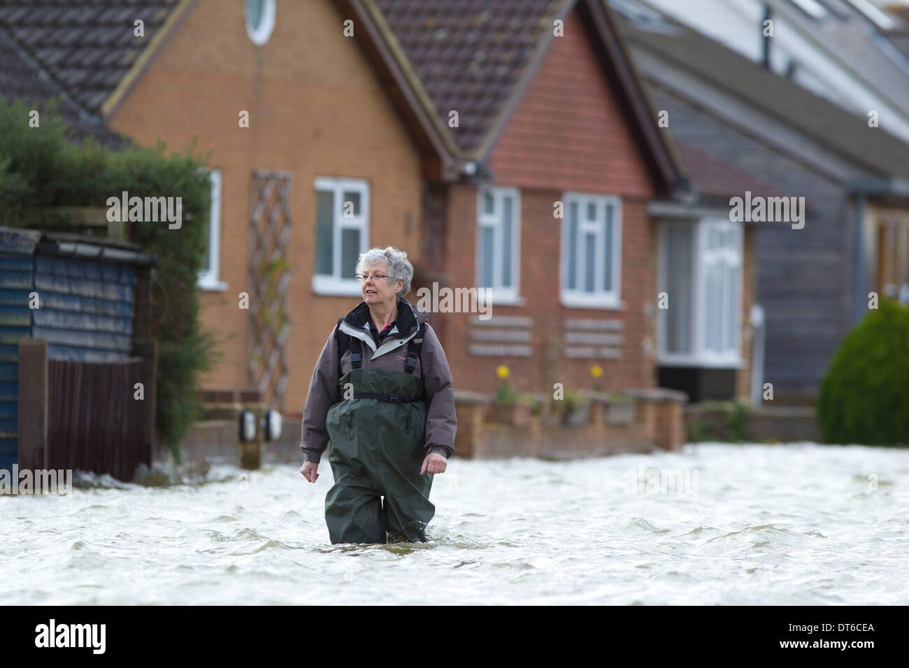 Shepperton, Greater London, UK. 9th Feb, 2014.  A woman makes her way through the flodded streets in the town of Shepperton, located in the borough of Spelthorne, Greater London. Credit:  Jeff Gilbert/Alamy Live News Stock Photo