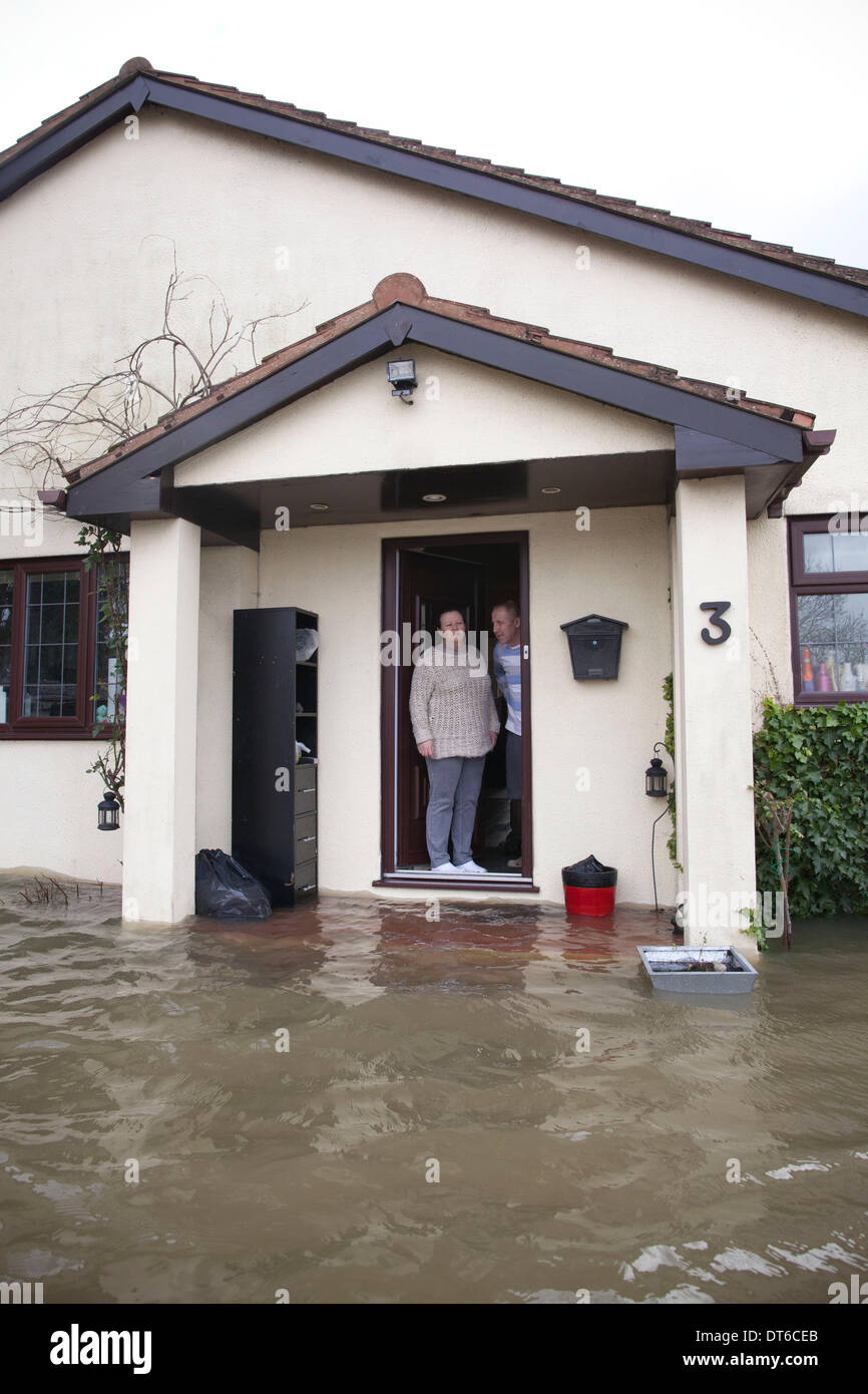 Shepperton, Greater London, UK. 9th Feb, 2014.  Christopher and Penny Holden look out of their front door onto the flooded streets in the town of Shepperton, located in the borough of Spelthorne, Greater London. Credit:  Jeff Gilbert/Alamy Live News Stock Photo