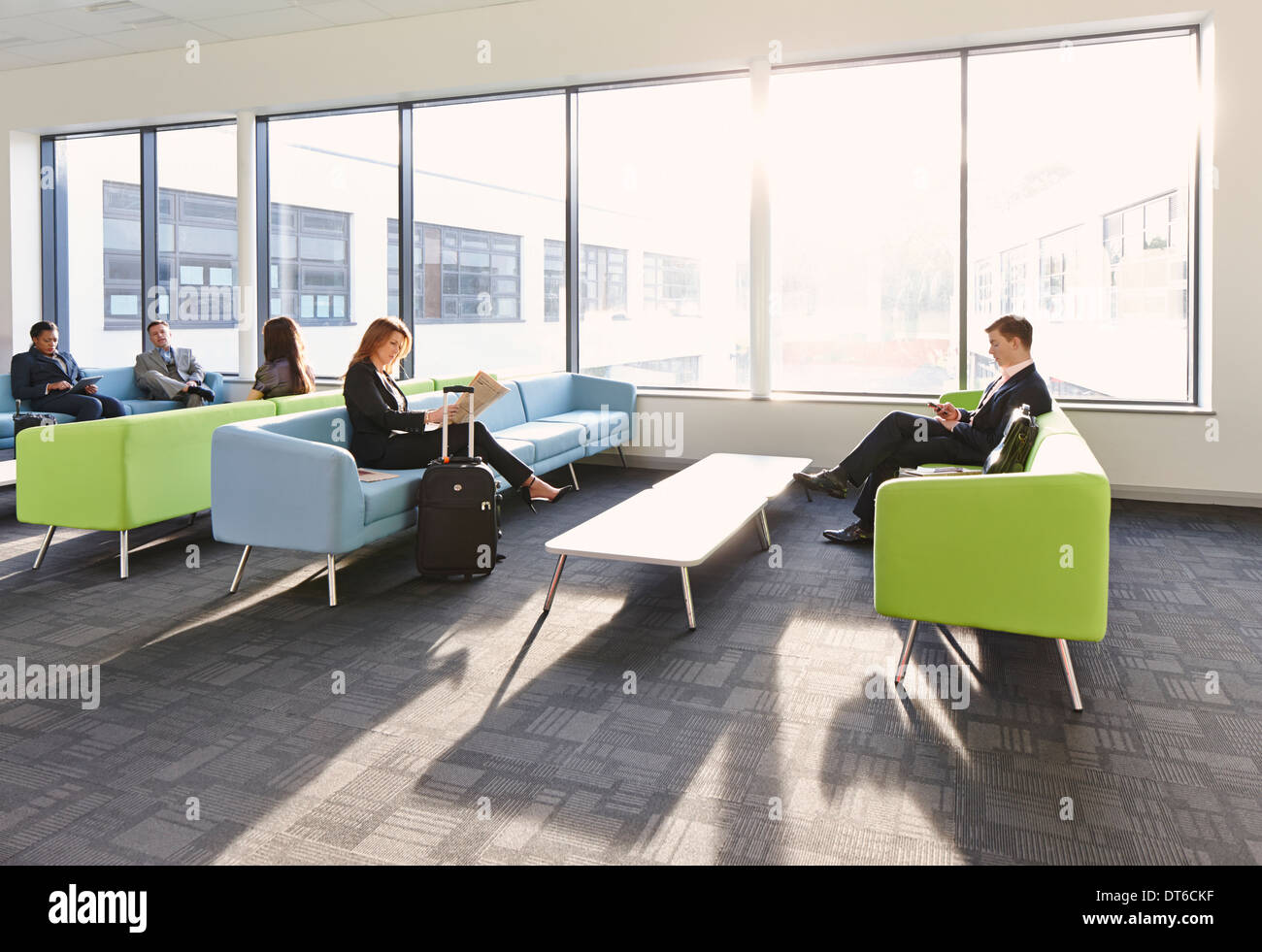 Businesspeople in departure lounge Stock Photo