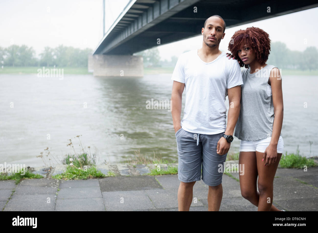 Portrait of young couple by bridge, Dusseldorf, Germany Stock Photo