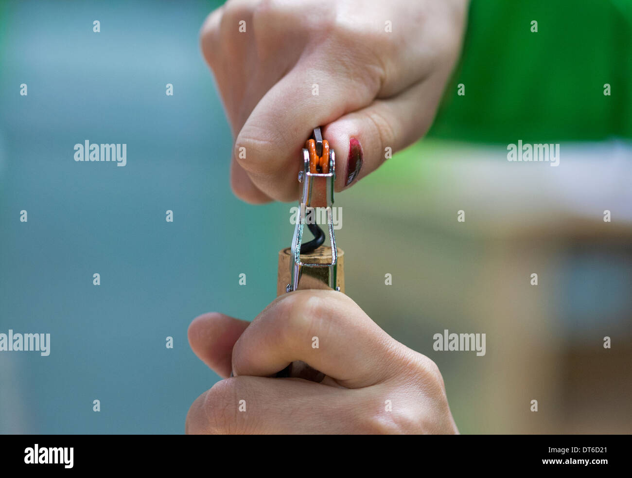 Opening a wine bottle with corkscrew closeup Stock Photo