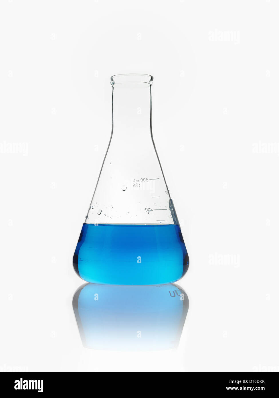 A conical scientific glassware flask partly filled with blue liquid. Stock Photo