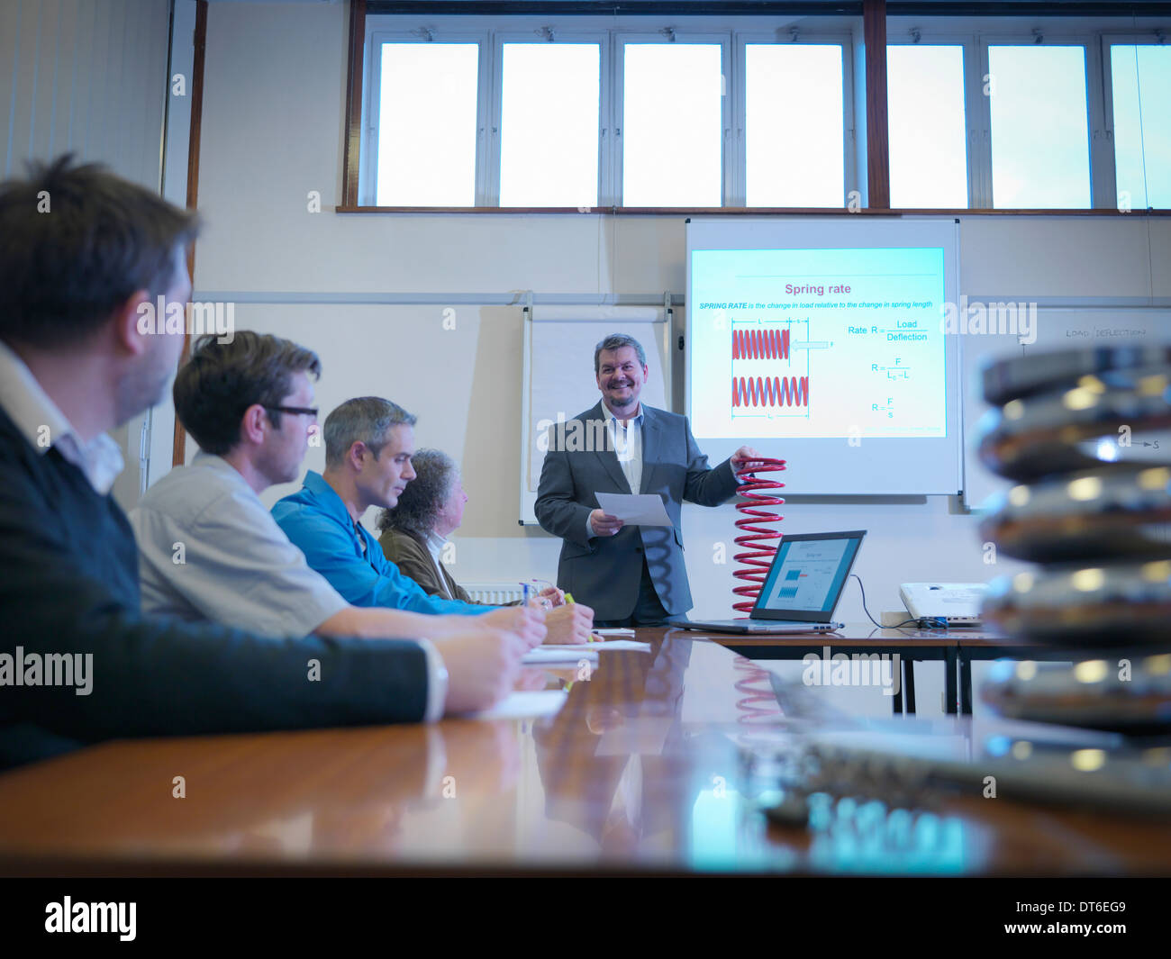 Scientist giving lecture about spring technology in conference room Stock Photo