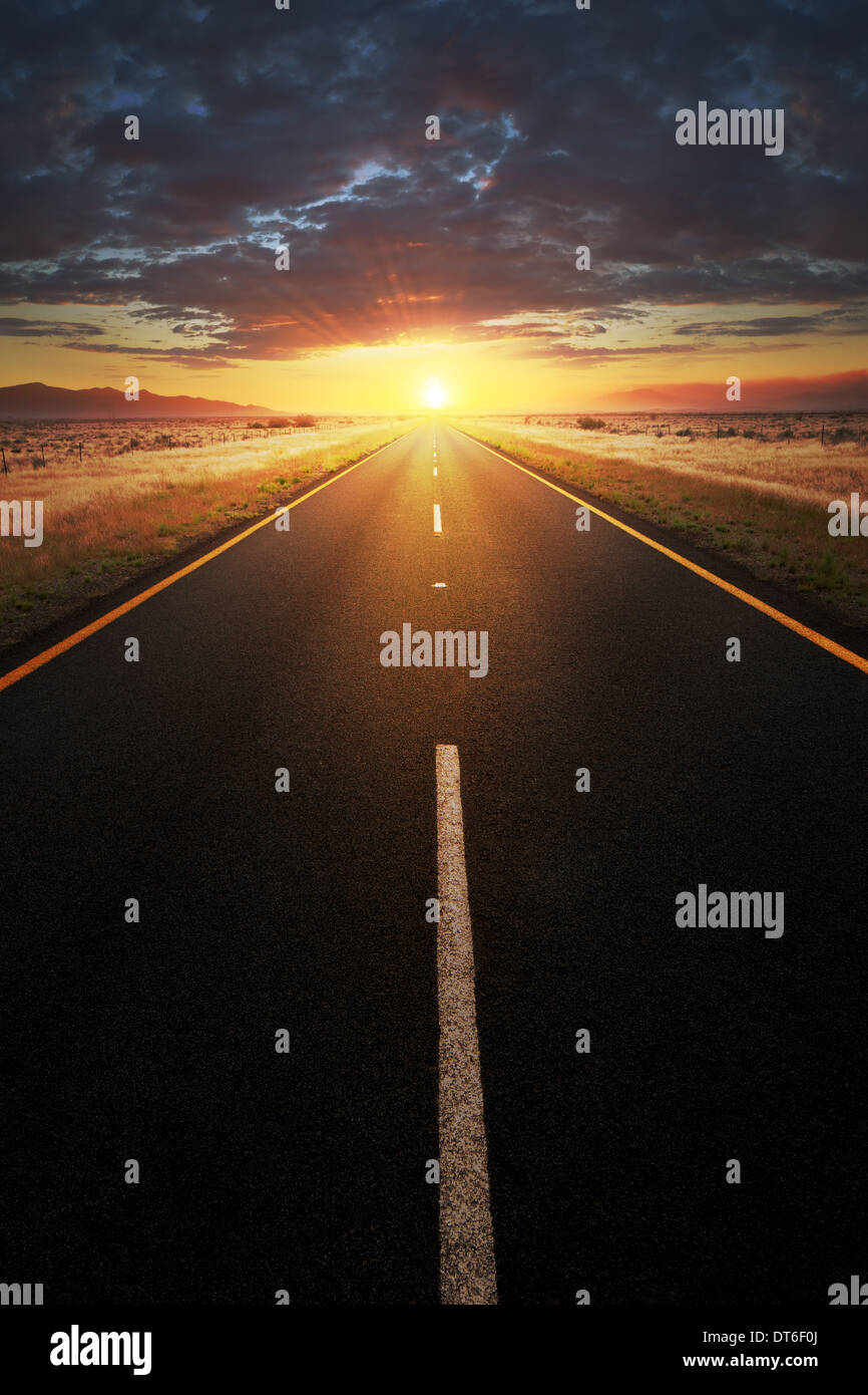 Conceptual image of a straight asphalt road leading into the light (composite work) Stock Photo