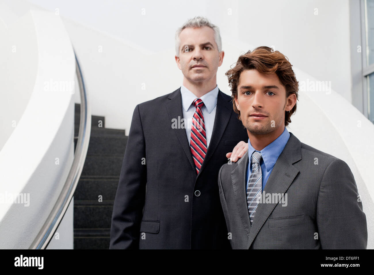 Portrait of two businessmen on office stairs Stock Photo - Alamy