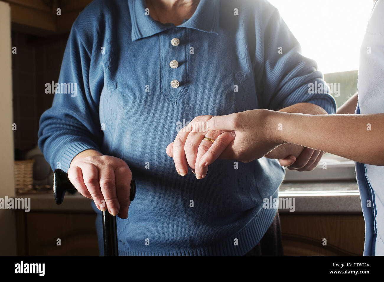 Personal care assistant supporting senior woman to walk Stock Photo Alamy