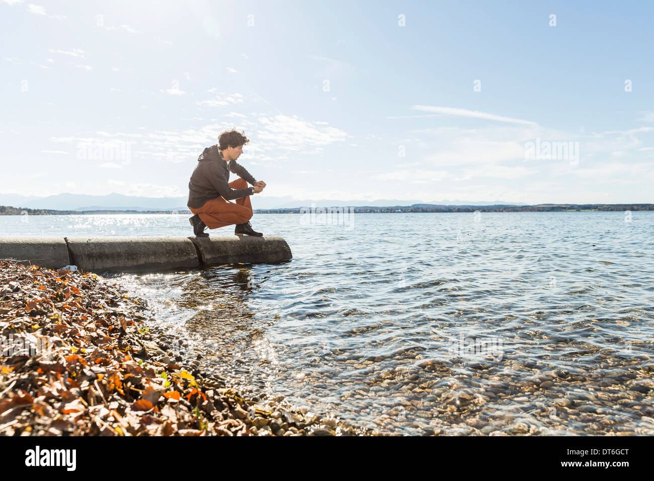 Man on jetty, Lake Starnberg, Bavaria, Germany Stock Photo