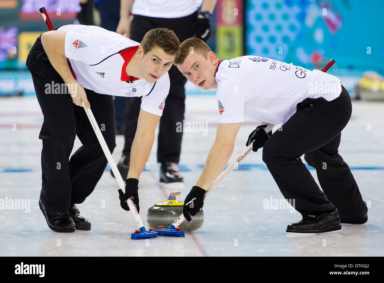 Sochi, Krasnodar Krai, Russia. 10th Feb, 2014. Great Britain's Greg DRUMMOND (right) & Scott ANDREWS sweep during the Men's Curling round robin match between Great Britain and Sweden at the Ice Cube Curling Centre - XXII Olympic Winter Game Credit:  Action Plus Sports/Alamy Live News Stock Photo