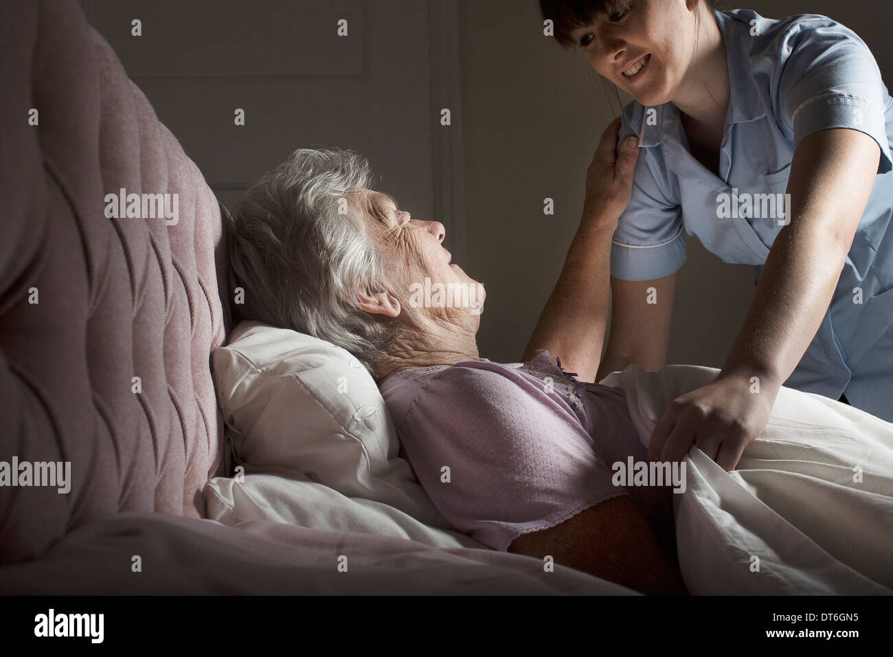 Old woman lying in bed hires stock photography and images Alamy
