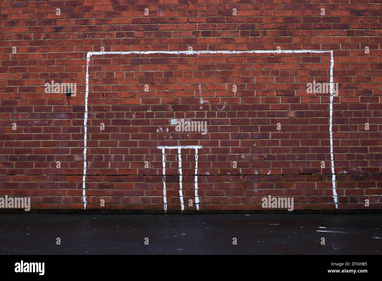 Cricket stumps & goalposts painted on a brick wall Stock Photo