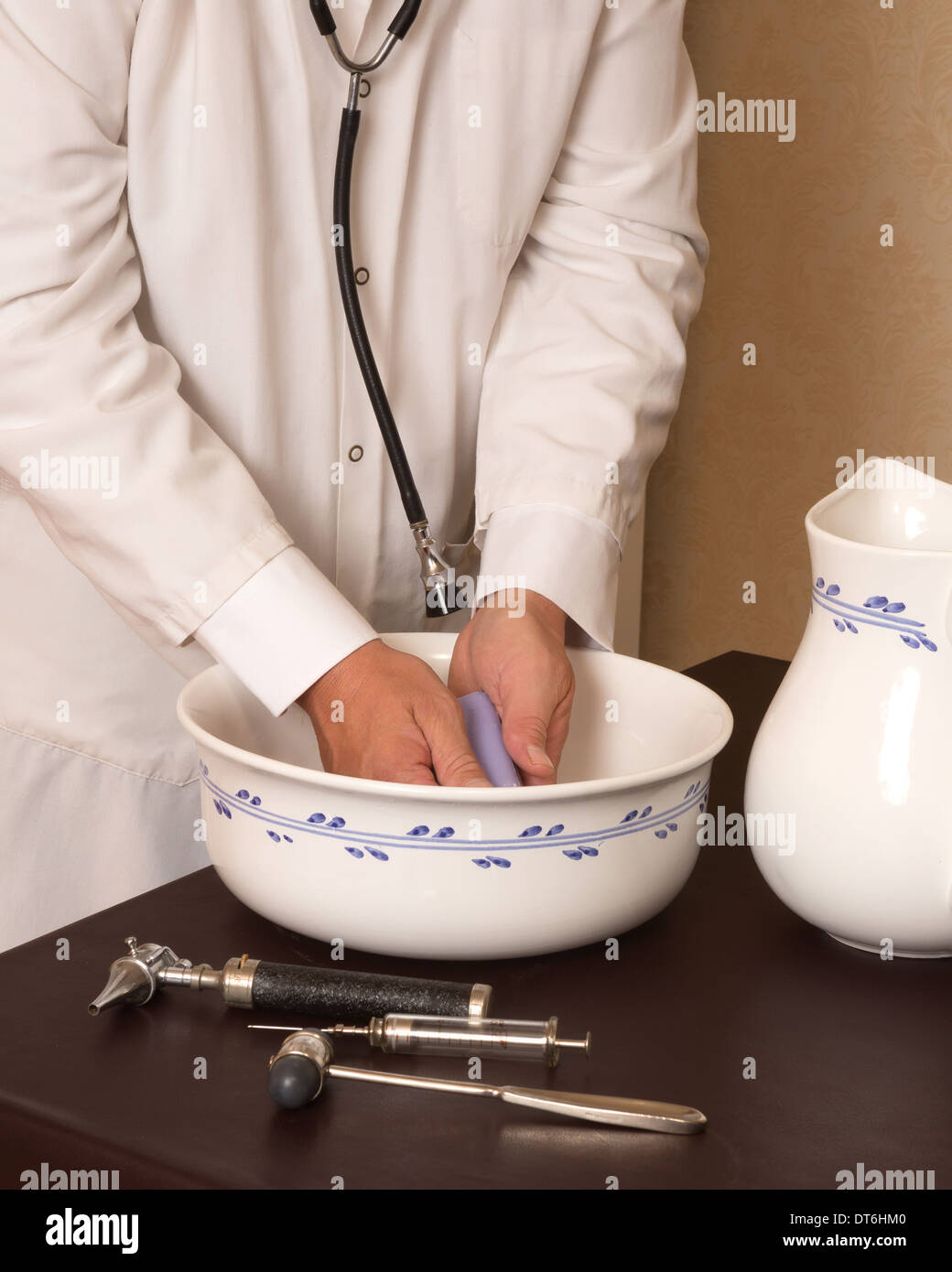 Old-fashioned doctor washing his hands in a basin Stock Photo