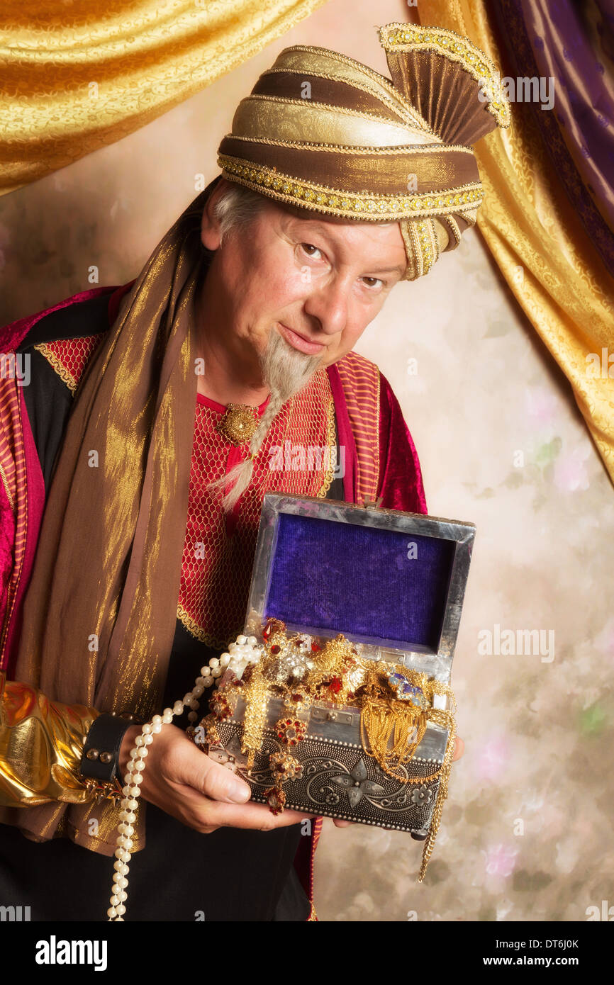 Arabian Genie bringing a treasure chest with gold and jewelry Stock Photo