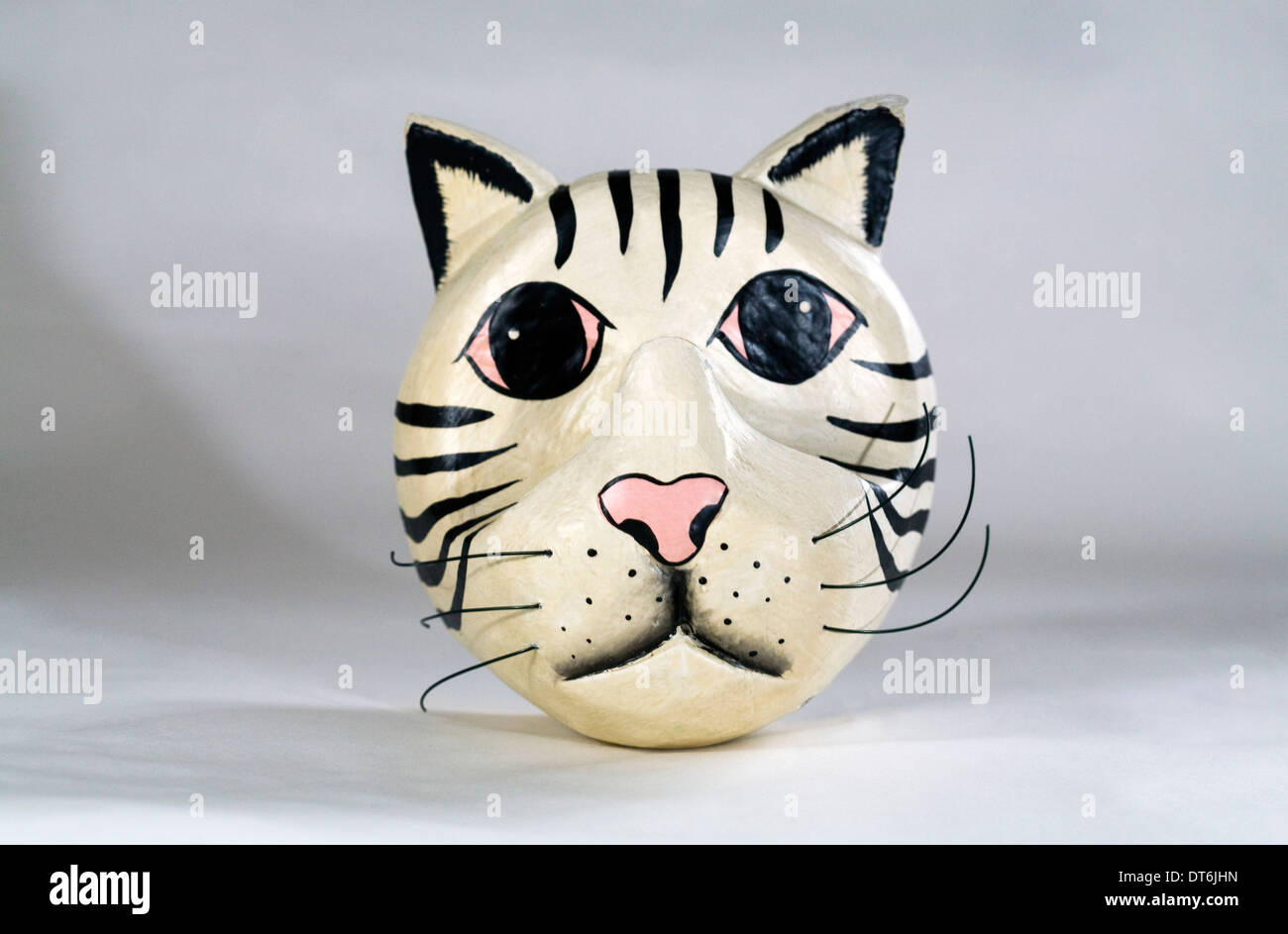A funny wooden painted cat face or tiger face with whiskers. Stock Photo