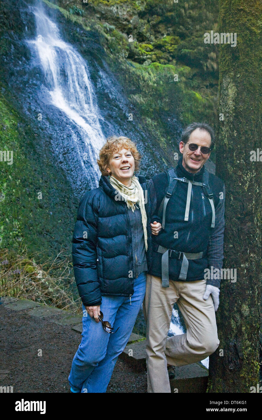 A middle-aged couple hiking in Silver Falls State Park, Oregon Stock Photo