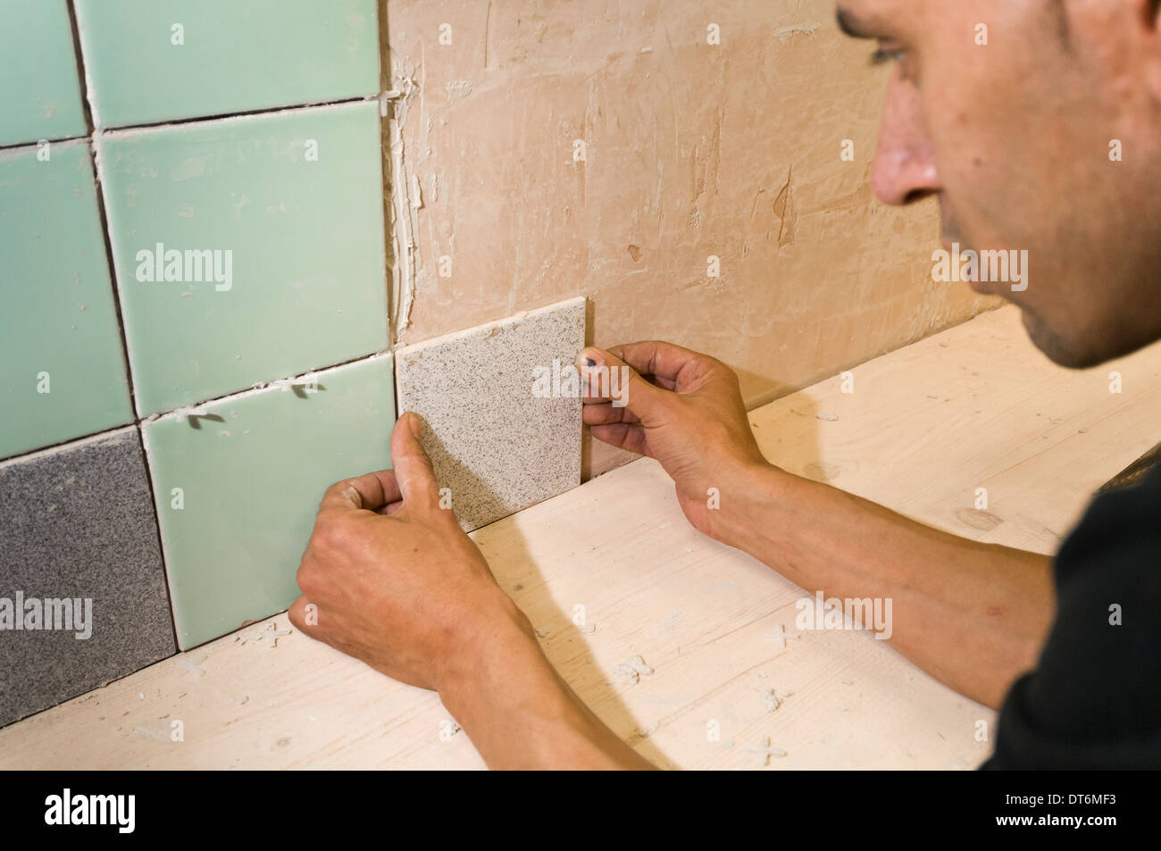 Man applying ceramic tile Stock Photo