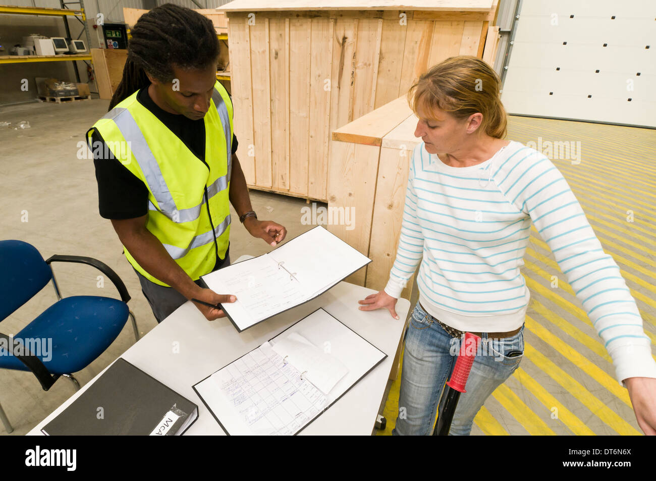 storeman-taking-a-delivery-in-a-warehouse-stock-photo-alamy