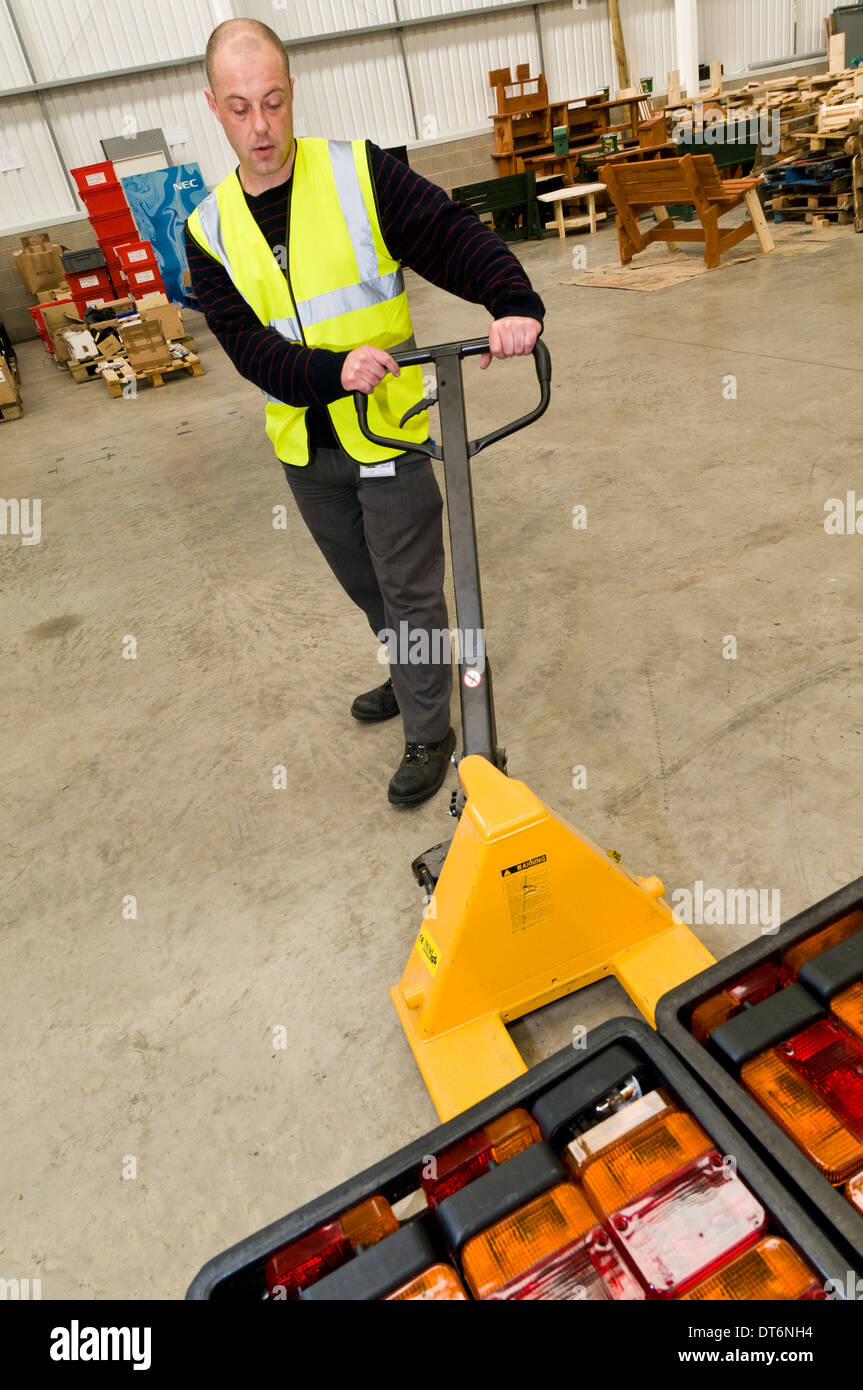 Man operating a pallet truck Stock Photo