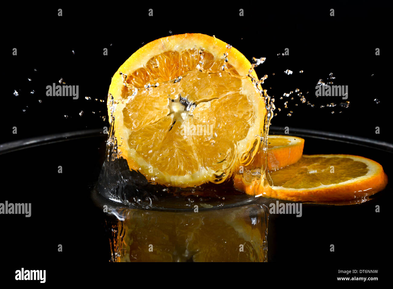 citrus fruit falling in water drops splashing everywhere. Concept of