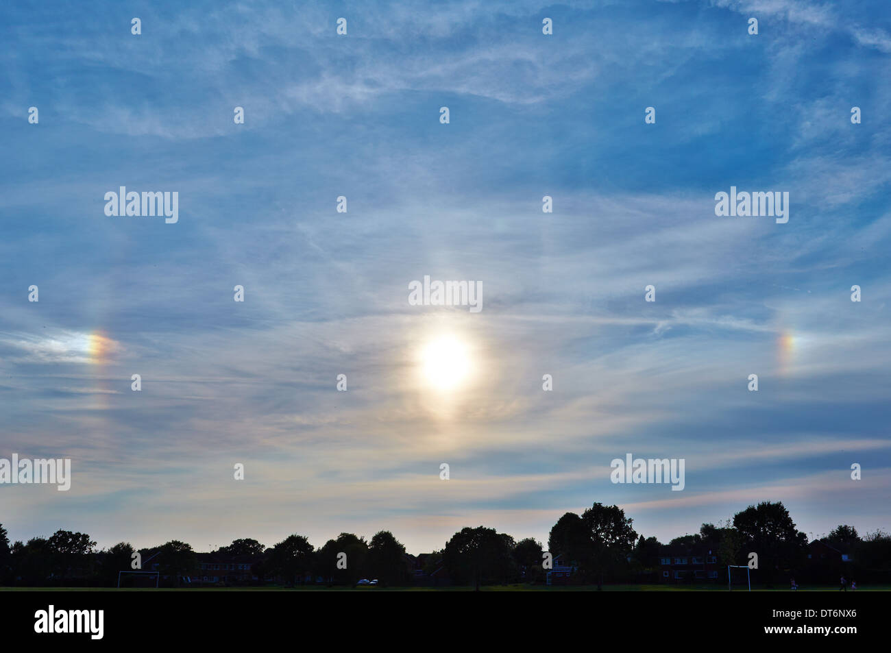 Sun dogs, or parhelion, formed by small ice crystals in the upper atmosphere Stock Photo