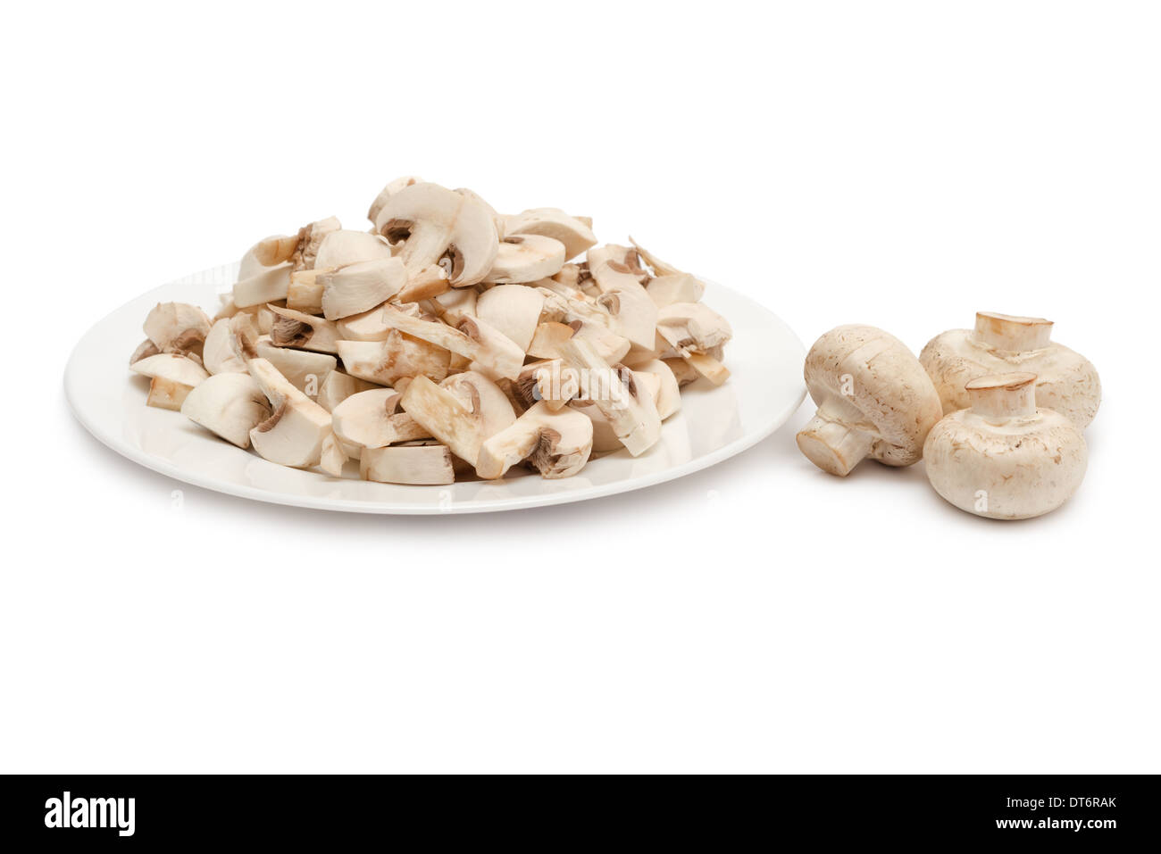 Sliced champignon mushrooms in plate isolated on white background. Side view. Stock Photo