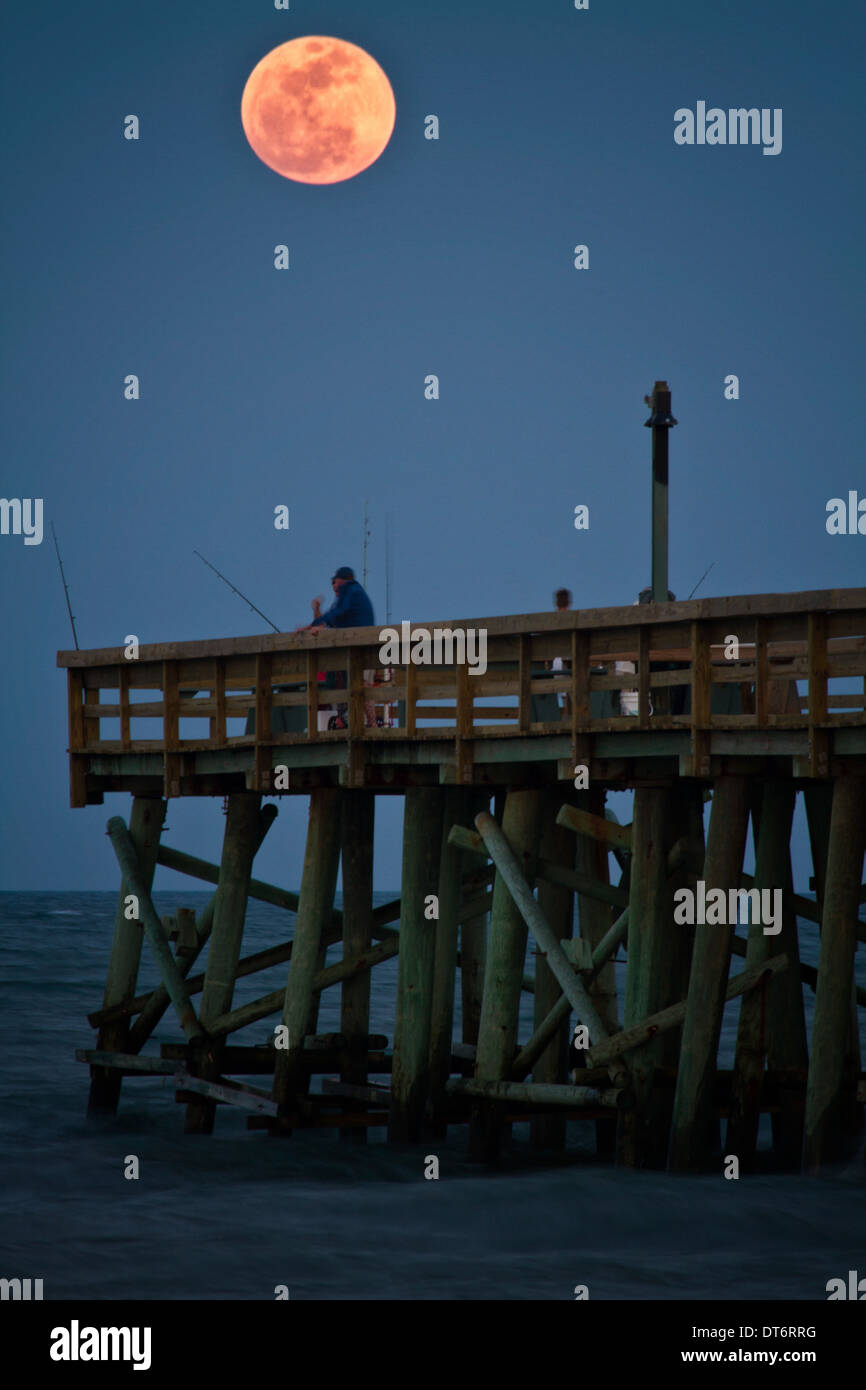 Super moon rising over the Fernandina Beach Pier on Amelia Island in Florida. Stock Photo