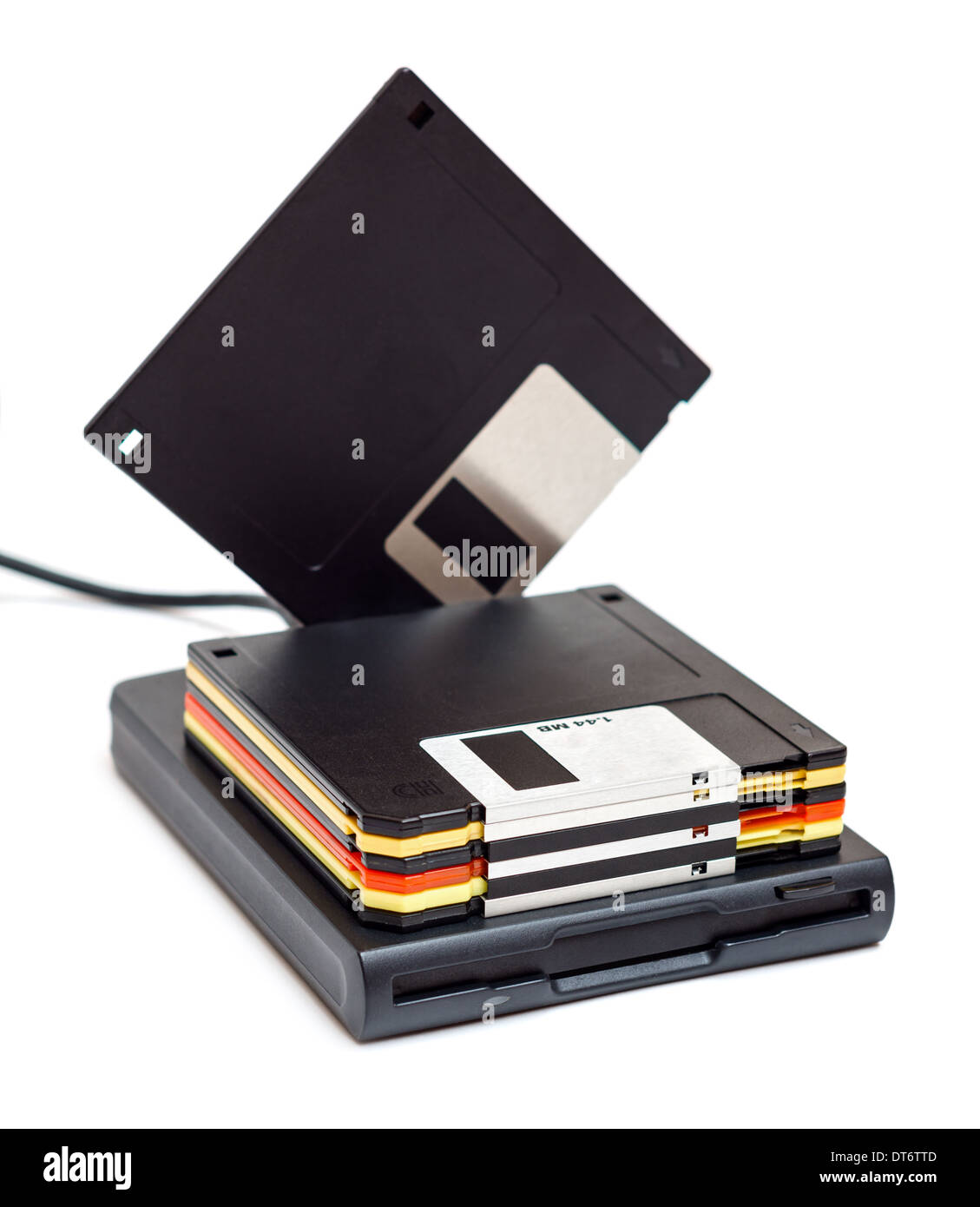 External usb floppy disk drive with disks, one standing isolated on white background Stock Photo
