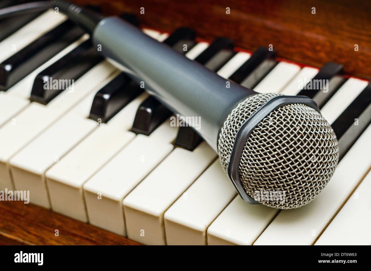 Electronic microphone on the keyboard of classical piano Stock Photo - Alamy