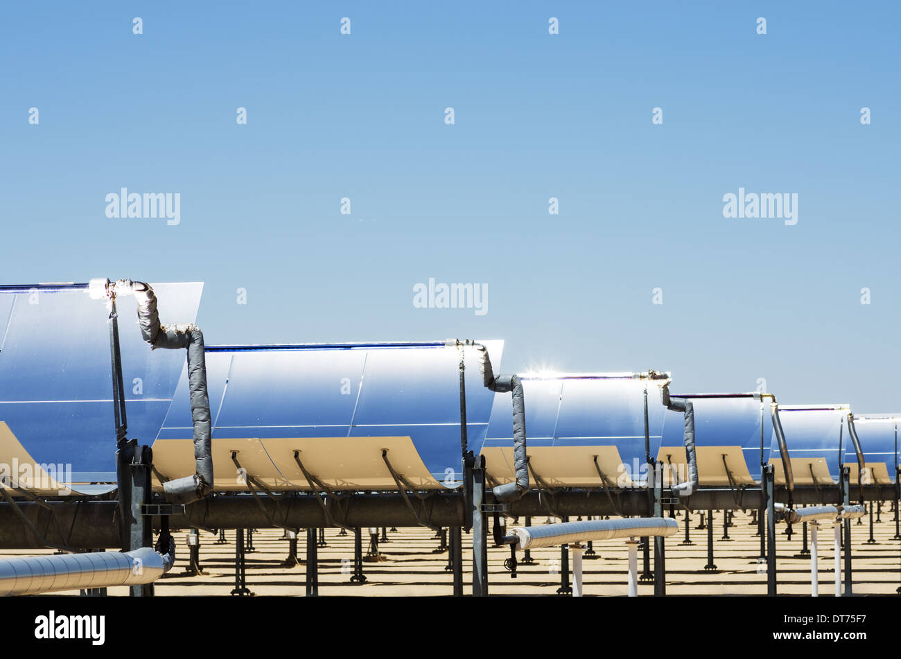 solar thermal electric generating plant collection mirrors with blue sky Stock Photo