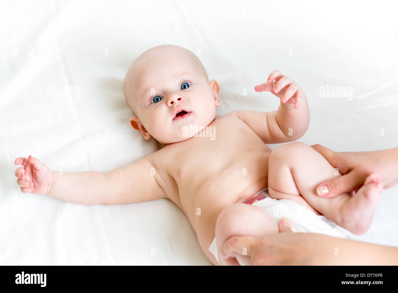 mother doing gymnastics her baby infant Stock Photo