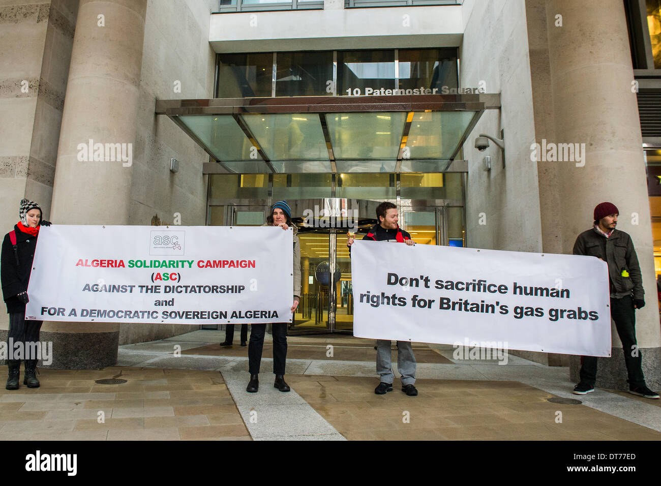 London, UK. 11th February 2014. Human rights protestors from the Algeria Solidarity Campaign (ASC) gather outside the London Stock Exchange to raise awareness about what they call ‘the repressive Algerian regime’ and its links with powerful multinationals such as BP who are keen on its gas reserves. Inside there is a business conference – The Algerian Investor Window – protestors hope to highlight issues about “British collusion with a repressive and corrupt regime for the sake of business interests and securing fossil fuel supplies” with the attendees. Credit:  Guy Bell/Alamy Live News Stock Photo