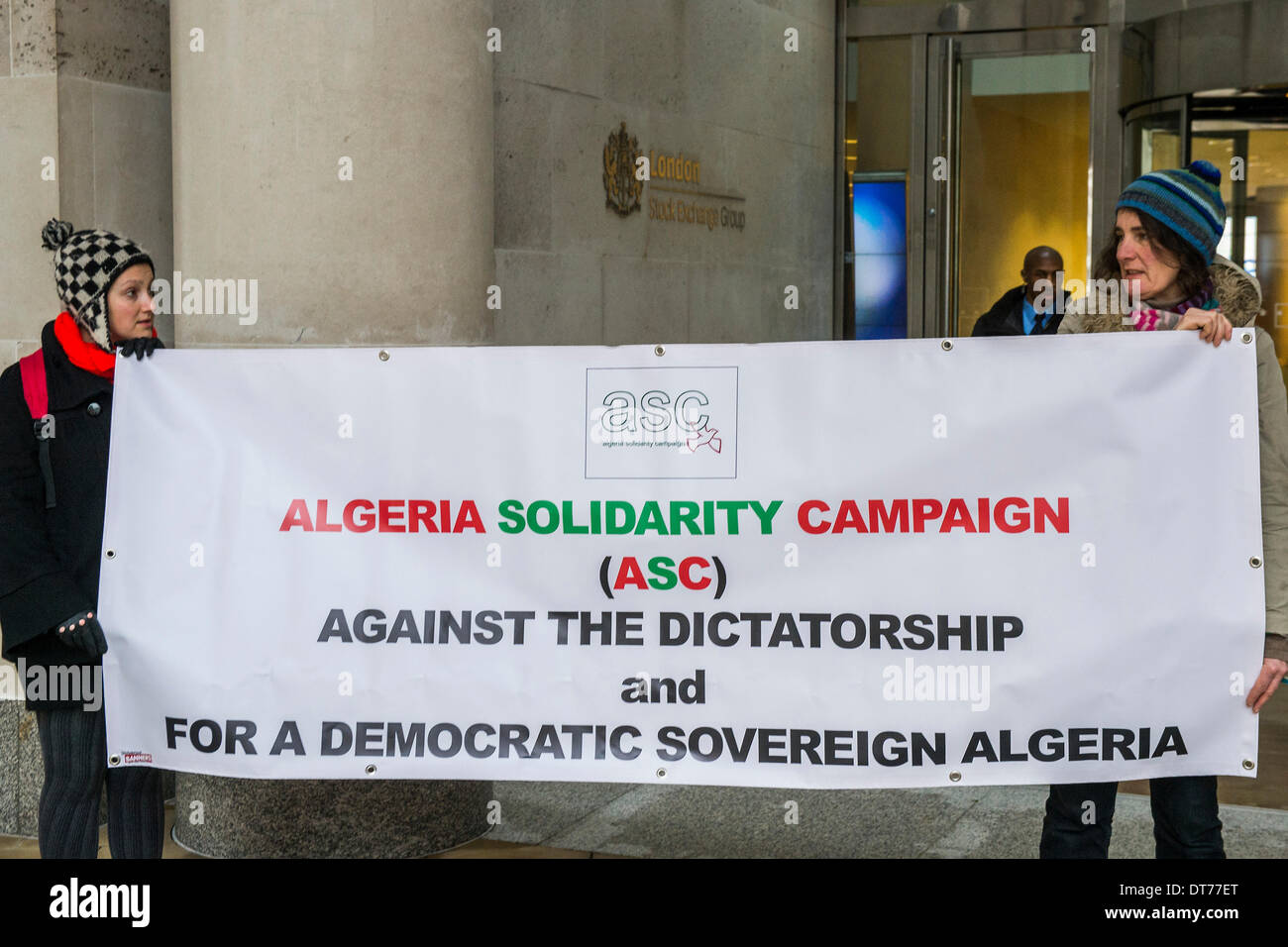 London, UK. 11th February 2014. Human rights protestors from the Algeria Solidarity Campaign (ASC) gather outside the London Stock Exchange to raise awareness about what they call ‘the repressive Algerian regime’ and its links with powerful multinationals such as BP who are keen on its gas reserves. Inside there is a business conference – The Algerian Investor Window – protestors hope to highlight issues about “British collusion with a repressive and corrupt regime for the sake of business interests and securing fossil fuel supplies” with the attendees. Credit:  Guy Bell/Alamy Live News Stock Photo