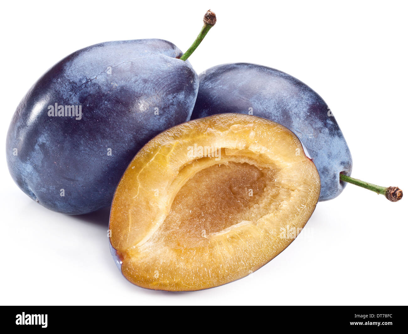 Plums with half of one isolated on a white background. Stock Photo