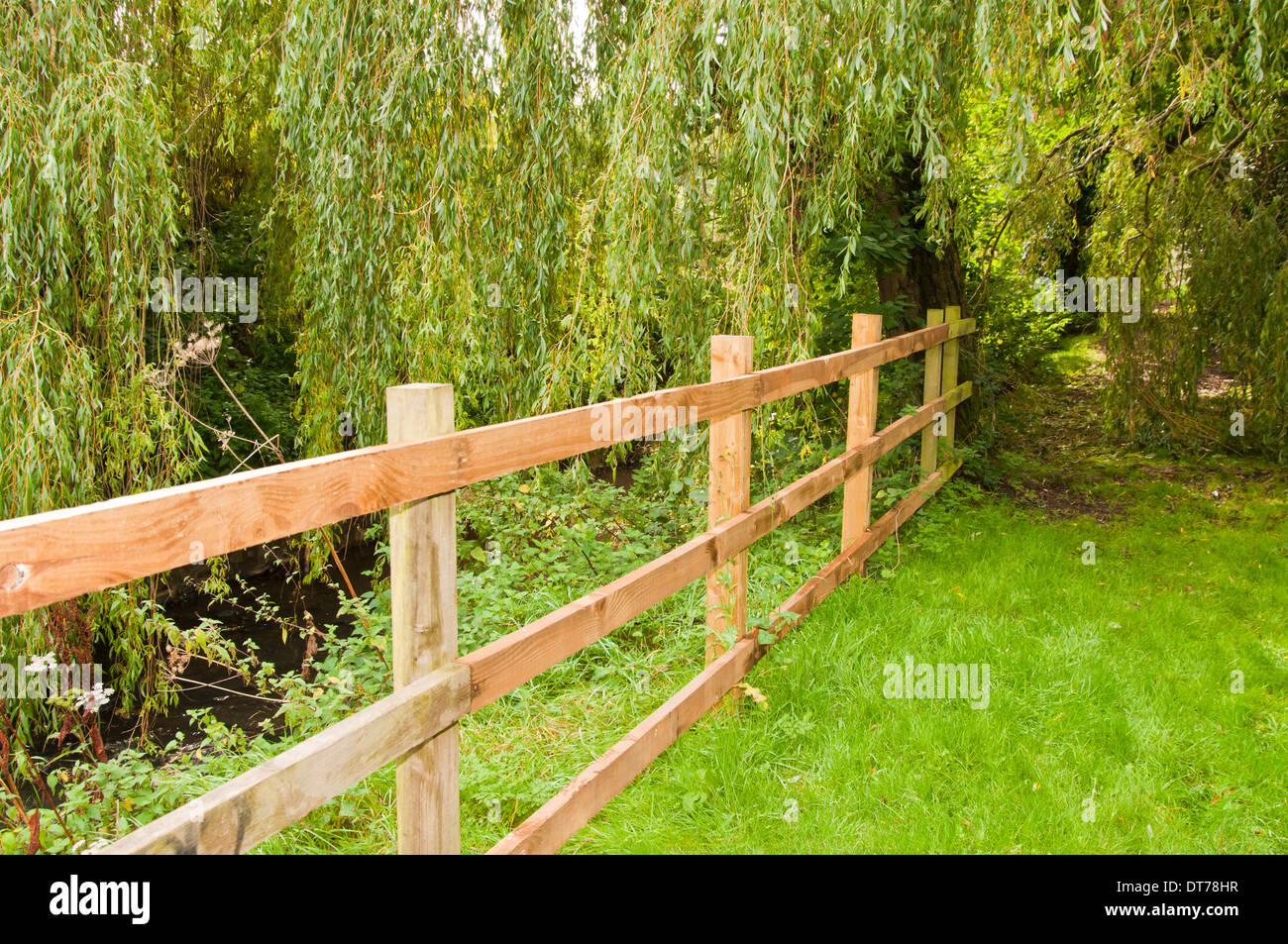 Wooden post and rail fence in the countryside Stock Photo