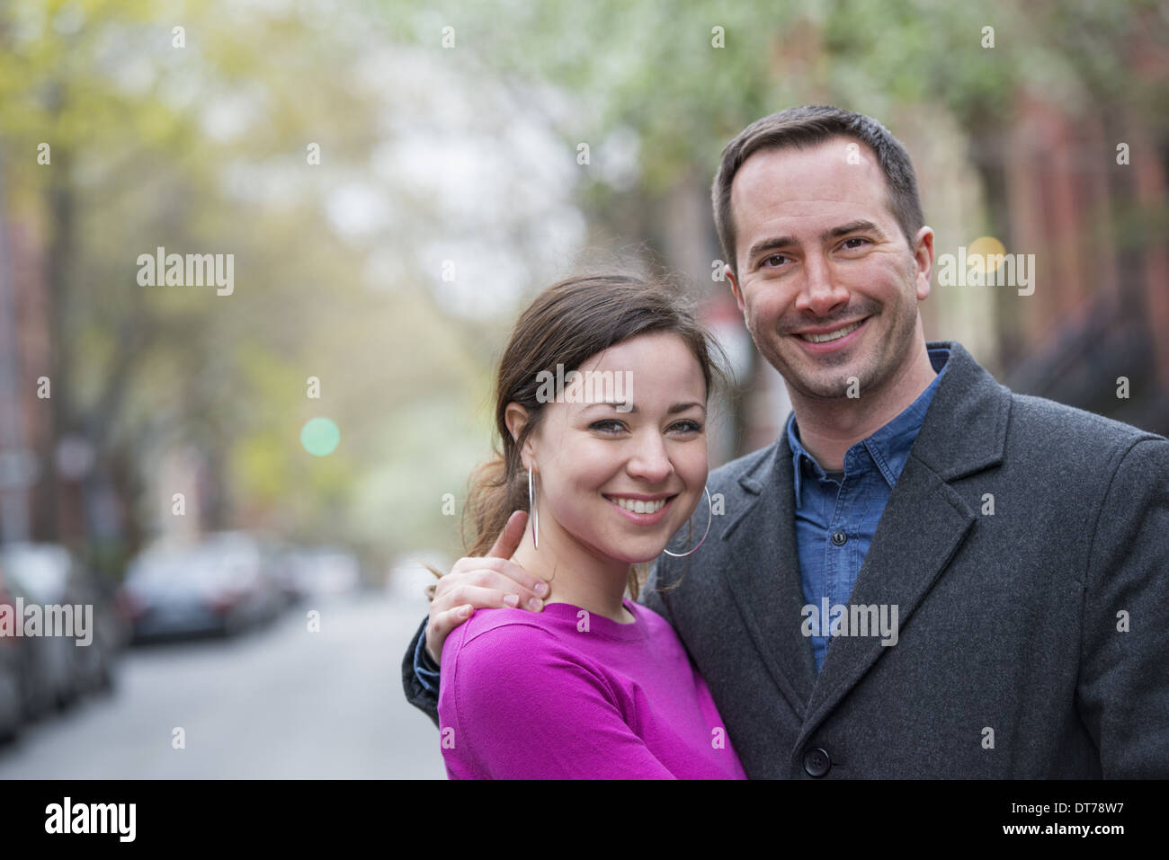 A couple, a man and woman side by side on a city street Stock Photo - Alamy
