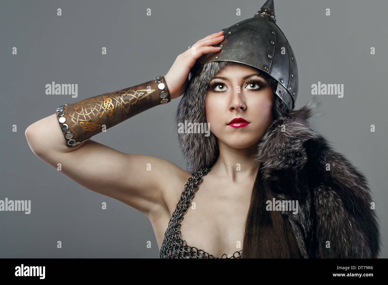 Attractive young girl with historical armor shot in studio Stock Photo
