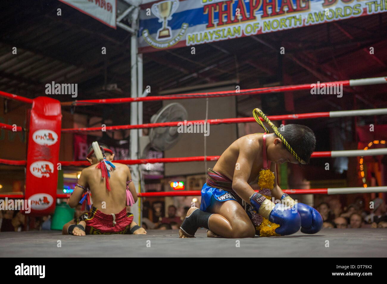 Chiang Mai, Thailand. 24th Jan, 2014. Focus and his opponent perform an elaborate ritual before their fight at the Thapae Muay Thai Stadium in Chiang Mai. PETCHFOGUS SITTHAHARNAEK, 9, aka Focus is the top fighter for his age and weight in Chiang Mai. He has begun fighting older, heavier opponents to continue to improve his skills. Fighters are typically paid 1000 baht ($30) per fight. © Taylor Weidman/ZUMA Wire/ZUMAPRESS.com/Alamy Live News Stock Photo