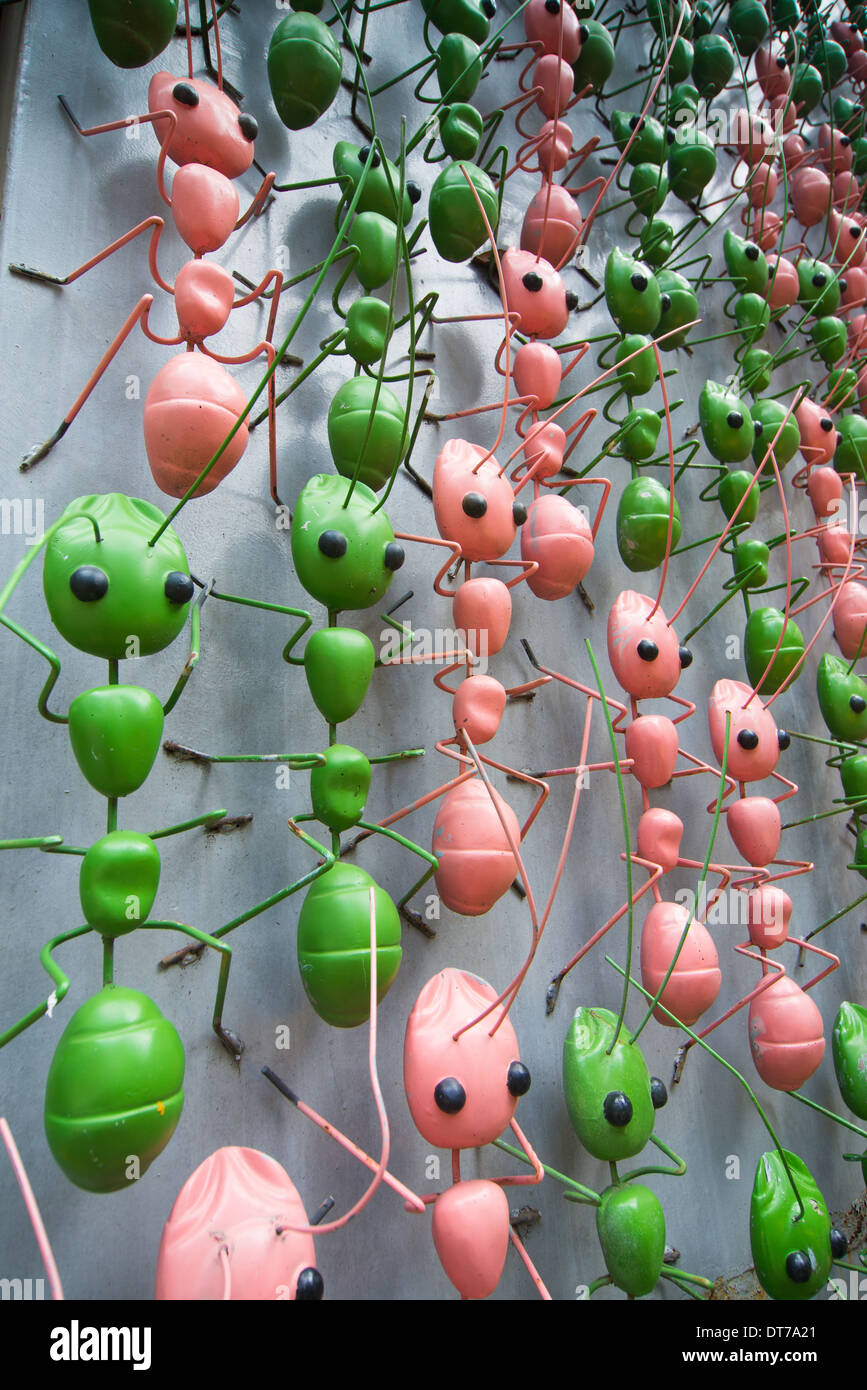 ants crawling up a concrete structure, a unique art installation at Nong Nooch Tropical Garden, Thailand Stock Photo