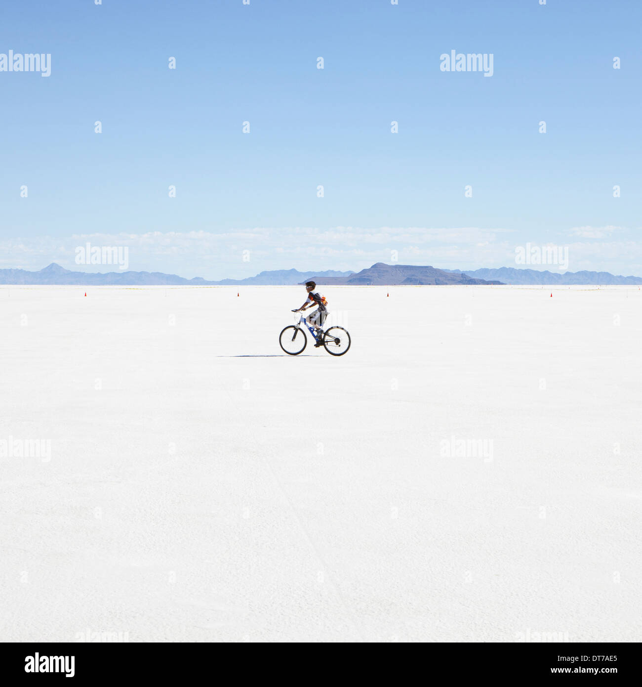Boy riding bike on salt flats during Speed Week Bonneville Salt Flats Utah USA Stock Photo