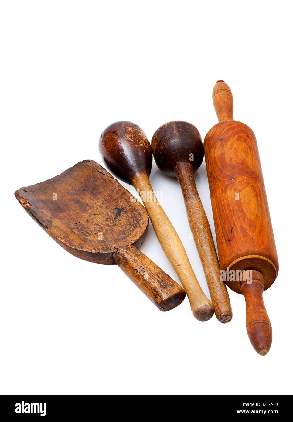 Four very old wooden kitchen utensils isolated on white background ...