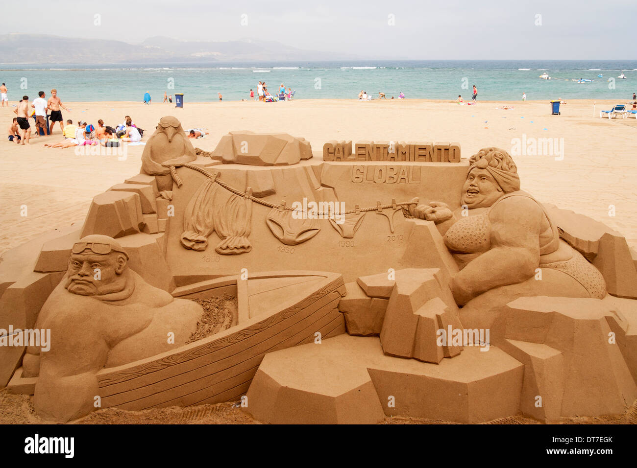 Global warming (calentamiento global in Spanish) sand sculpture on beach in Spain Stock Photo