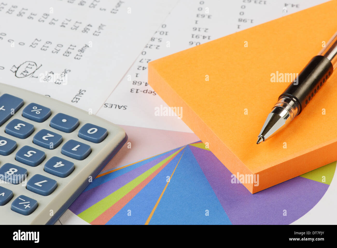 Pen,pad and calculator on accounts spreadsheet showing sales Stock