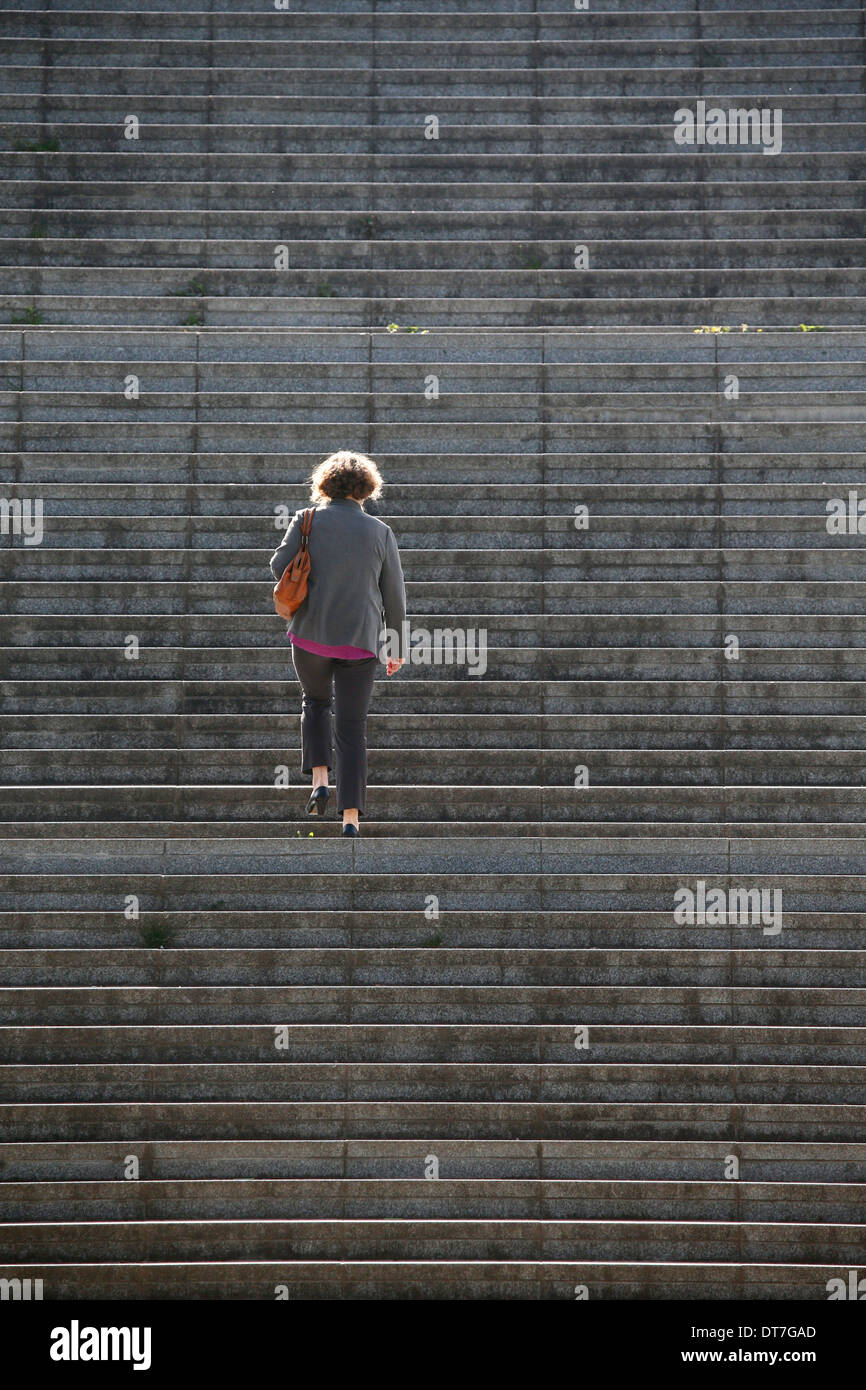 Man walking up a staircase Stock Photo