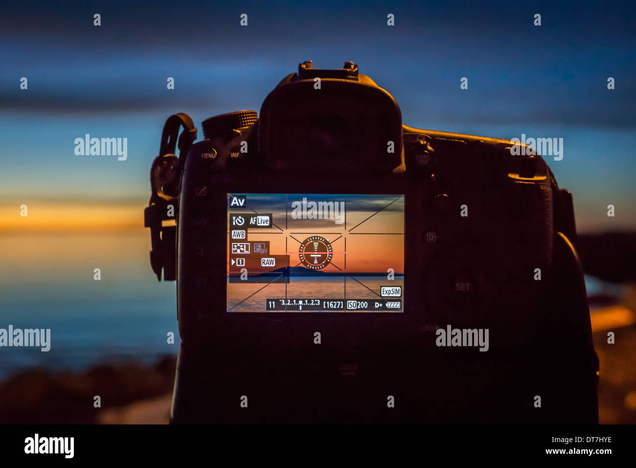 DSLR camera back with sunset image on the screen. Canon EOS 5D Mark III. Stock Photo
