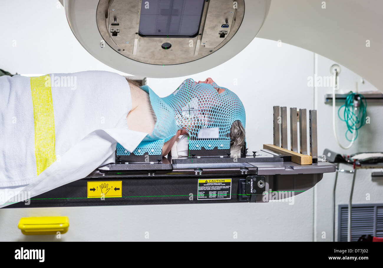 Male cancer under a linear accelerator or linac receiving radiation ...
